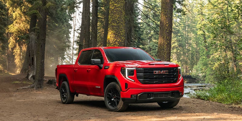 2026 GMC Sierra 1500 red truck in forest