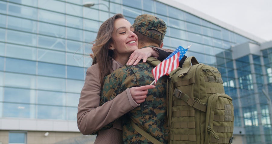 A soldier hugs to his wife